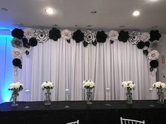 the table is set up with white and black flowers