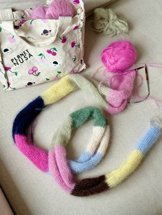 knitted items laid out on a white couch