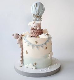 there is a cake that looks like it has animals on top and balloons in the air