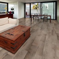 a living room filled with furniture and a wooden trunk in the middle of the floor