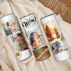 three cans with pictures on them sitting on a bed next to a basket and blanket