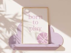 a wooden shelf with a sign that says born to play and a basketball on it