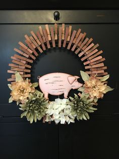 a pink pig sitting on top of a wreath