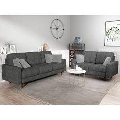 a living room with two gray couches and a coffee table in front of it