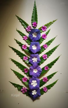 purple and white flowers are arranged on green leaves