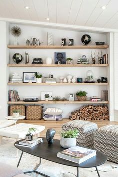 a living room filled with lots of furniture and shelves