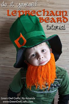 a young boy wearing a leprechan beard and green hat with orange fringes