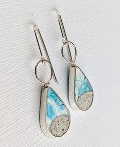 These dangle teardrop earrings with real sand and hand colored eco resin, mixed with crushed stones and silver specks and poured/painted individually. Each earring measures approx. 1.25 inch high and hangs at about 1.75 inches from the ear. The body and wiring is made with Sterling Silver. Made to order option, Please allow 10-14 days while I make this earrings especially for you. Slight variations in color and sand shapes are expected since all my work is handmade by me one piece at a time - I Unique Teardrop Earrings, Handmade Resin Teardrop Jewelry, Sea Glass Teardrop Earrings For Beach, Resin Drop Earrings For Beach, Nickel-free Teardrop Earrings For Beach, Resin Dangle Earrings For Beach, Turquoise Teardrop Hand Painted Earrings, Turquoise Hand Painted Teardrop Earrings, Unique Teardrop Resin Earrings