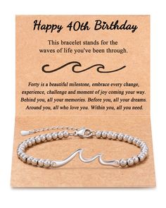 a birthday card with a silver bracelet on it and an inscription that says happy 40th birthday