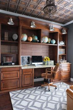 a home office with wooden cabinets and shelves filled with vases, bookshelves, and flowers