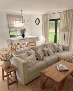 a living room filled with furniture and a wooden table in front of a sliding glass door