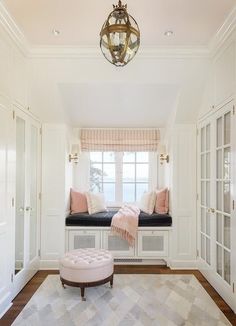 a white room with two windows and a bench