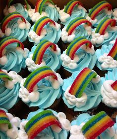 cupcakes with blue frosting and rainbow decorations