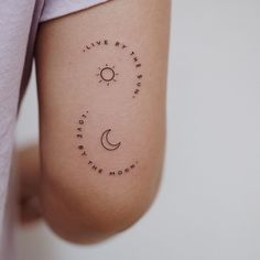 a person with a tattoo on their arm that says live by the sun, love by the moon