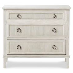 a white dresser with three drawers and two pulls on the bottom drawer, against a white background