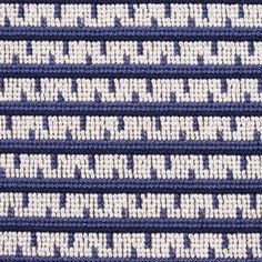 blue and white knitted fabric with small letters on the front, diagonally arranged