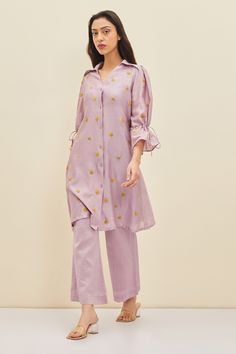 Lilac shirt tunic with floral embroidery, tie-up detail and frill sleeves. Comes with pant.
Component: 2
Pattern: Embroidered
Type Of Work: Floral
Neckline: Spread Collar
Sleeve Type: Frill Sleeves
Fabric: Silk, Cotton Chanderi
Color: Purple
Other Details: 
Floral embroidery
Closure: Front buttons
Occasion: Work - Aza Fashions Lilac Care, Floral Hand Embroidery, Blouse Yoke, Modest Maxi Dress, Modest Maxi, Pants Fabric, Silk Tunic, Frill Sleeves, Purple Silk