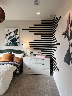 a bedroom with black and white stripes on the wall