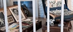 an open suitcase sitting on top of a wooden table next to pictures and other items