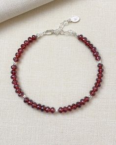 Faceted garnet beads sparkle within this bracelet, complemented by sterling silver components. Let January's birthstone brighten your look. Bracelet length: 7 inches plus 1-inch extender Materials: 4 mm garnet beads, sterling silver Elegant Adjustable Garnet Bracelets, Elegant Sterling Silver Crystal Bracelet With Faceted Beads, Elegant Adjustable Sterling Silver Bracelet With Faceted Beads, Elegant Sterling Silver Beaded Bracelet With Faceted Beads, Elegant Sterling Silver Bracelets With Faceted Beads, Elegant Sterling Silver Crystal Bracelet With Gemstone Beads, Elegant Sterling Silver Beaded Bracelets With Gemstone, Elegant Burgundy Bracelets As Gifts, Elegant Burgundy Jewelry With Faceted Beads