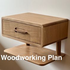 a wooden shelf with a drawer on it and a white wall in the back ground