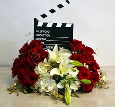 red roses and white lilies in front of a clap board