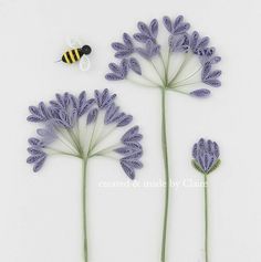 three purple flowers and a bee on a white background