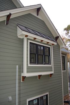 a gray house with white trim and windows