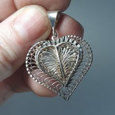 Sterling Silver Filigree Heart Pendant made in Turkey. This solid silver pendant features an openwork wire filigree design with chiseled textures. The pendant is hallmarked 925 Turkey on the bail. Condition is very good, light scuffs and scratches on silver surface. Thank you for looking! We are a licensed gold and silver buyer in the state of California; all of our items are tested for purity and authenticity. No reserve please, all items sold as is. Please let us know if you have any questions Wire Filigree, Filigree Heart, Victorian Pendants, Celtic Knot Ring, Cabochon Ring, Sterling Silver Filigree, Filigree Design, Heart Locket, Silver Filigree