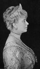 an old black and white photo of a woman wearing a tiara