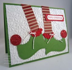 a close up of a christmas card on a white surface with red and green decorations