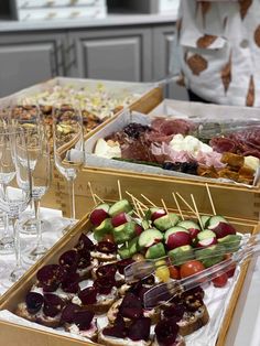 an assortment of appetizers and wine glasses on a table