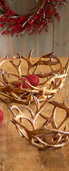 antlers and berries sit on a wooden table