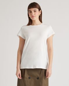 A wardrobe basic that feels anything but. Our Cotton Modal Crewneck Swing Tee is made with a super soft and stretchy cotton blend that's wrinkle-resistant with a seriously smooth finish.  | Quince | Women's Cotton Modal Crew Neck Swing Tee in White, Size Medium, Cotton/Modal Versatile T-shirt With Shirttail Hem, Basic Stretch Plain Tops, Classic Stretch T-shirt For Workwear, Spring Plain Stretch T-shirt, Everyday Basic Style Top In Solid Color, Solid Color Basic Style Tops For Everyday, Versatile Fitted T-shirt, Everyday Basic Style Solid Color Tops, Spring Stretch Plain T-shirt