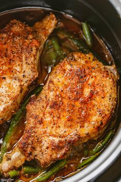 two pieces of chicken in a pot with green beans