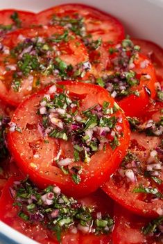 tomatoes with herbs and seasoning in a white bowl