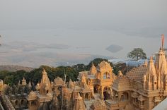 an aerial view of a castle like building with many spires and towers in the foreground