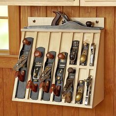 a pair of scissors is hanging on a wooden rack with many different types of tools