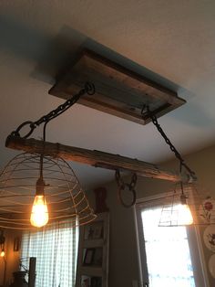 two light fixtures hanging from the ceiling in a kitchen