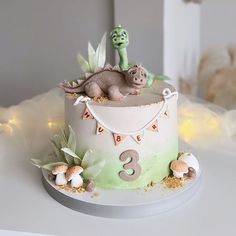 a birthday cake decorated with an image of a dragon and another animal sitting on top of it