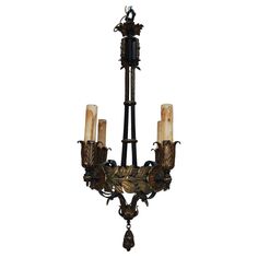 an antique chandelier with four candles on it