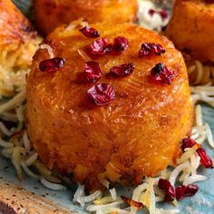 a close up of some food on a plate with noodles and cranberry toppings