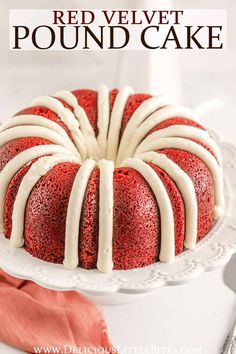 a red velvet pound cake with white icing on a platter next to a fork