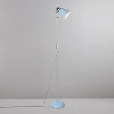 a floor lamp with a blue base and a white light on the top of it