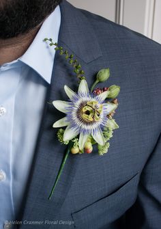 a man in a suit with a boutonniere on his lapel