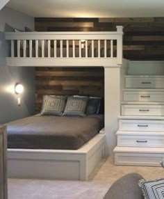 a bedroom with a loft bed next to a white dresser and stairs in the wall