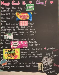 a chalk board with candy bars on it and some words written in the writing area