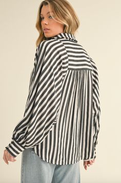 + Striped button down batwing sleeve top + Collared neckline with button down placket + Batwing sleeves with buttoned cuffs + Relaxed fit + Curved shirttail hem + Model is 5' 10.5" 32-24-36 and wears a S50% COTTON 50% POLYESTER Oversized Striped Collared Blouse, Casual Button-up Shirt With Blouson Sleeves, Striped Relaxed Fit Button-up Blouse, Casual Button-up Blouse With Blouson Sleeves, Button-up Blouse With Blouson Sleeves, Daywear Button-up Shirt With Blouson Sleeves, Fall Daywear Blouse With Rolled Sleeves, Rolled Sleeves Blouse For Day Out In Fall, Chic Blouse With Rolled Sleeves For Fall