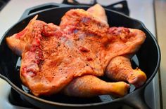 a pan filled with meat sitting on top of a stove