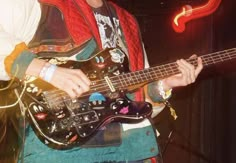 a young man is playing an electric guitar